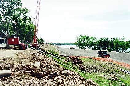 Workers prepare the river bank for the new road in June 1999.